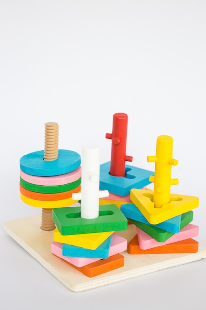 Colorful puzzle wooden toy on white table