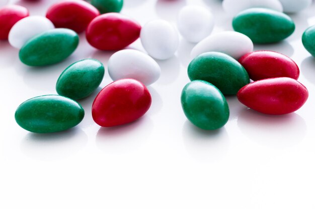 Colorful red, green and white candies on white background.