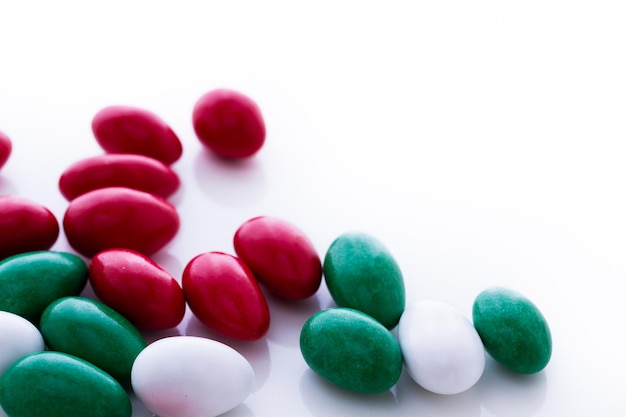 Colorful red, green and white candies on white background.