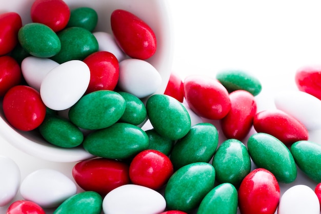 Colorful red, green and white candies on white background.