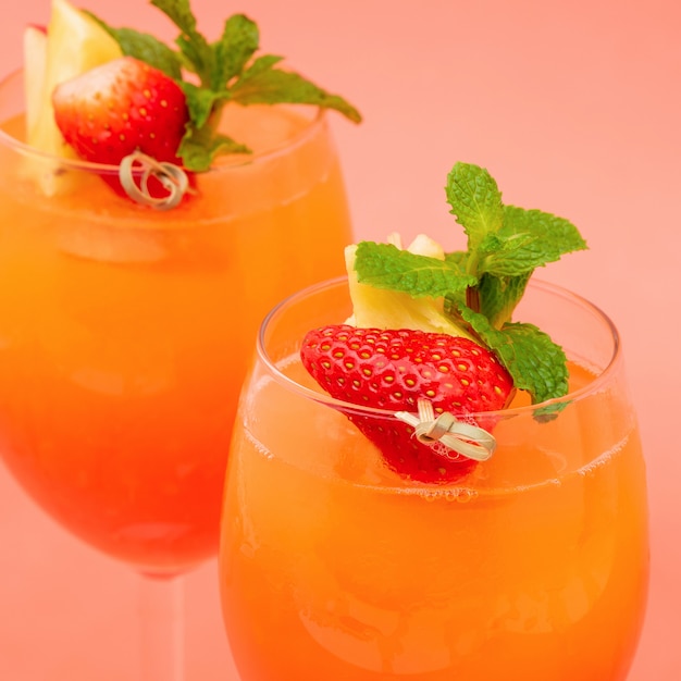 Colorful refreshing strawberry orange sunrise cocktail drinks in the glasses