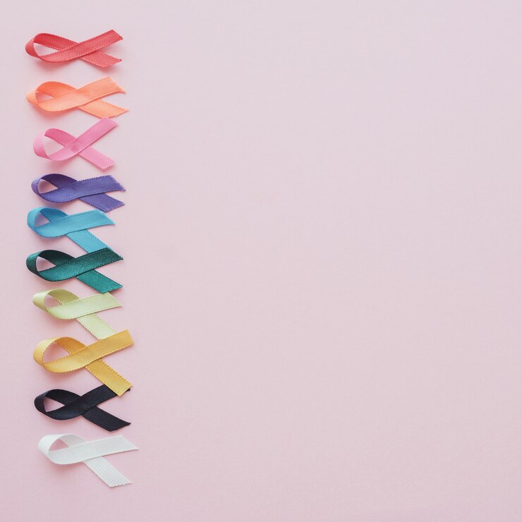 Colorful ribbons on pink background, cancer awareness
