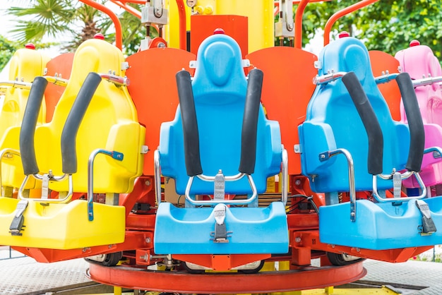 Colorful roller coaster seats at amusement park