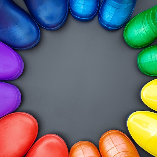 Colorful rubber boots of all colors of the rainbow stand 