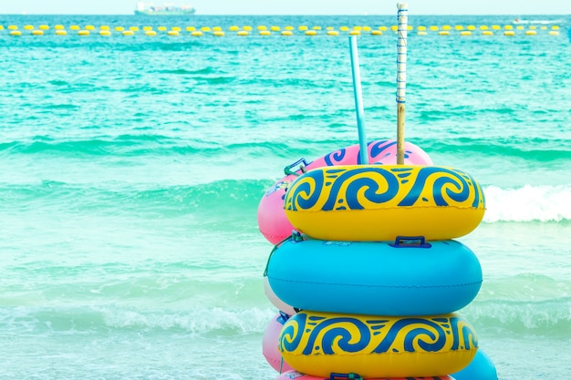 Colorful rubber rings stacked on the beach.