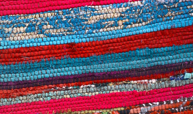 Colorful rug surface close up vintage fabric is made of handwoven cotton fabricDisplay in bazaardetails