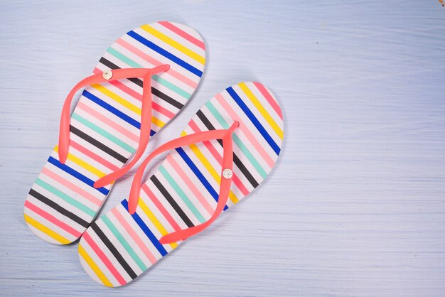 Colorful sandals on white background top down .