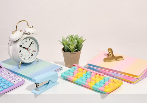 Colorful school stationery Pencil case notepads calculator and alarm clock