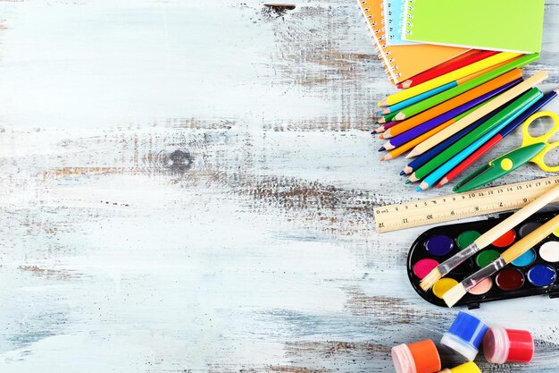 Colorful school stationery on wooden background