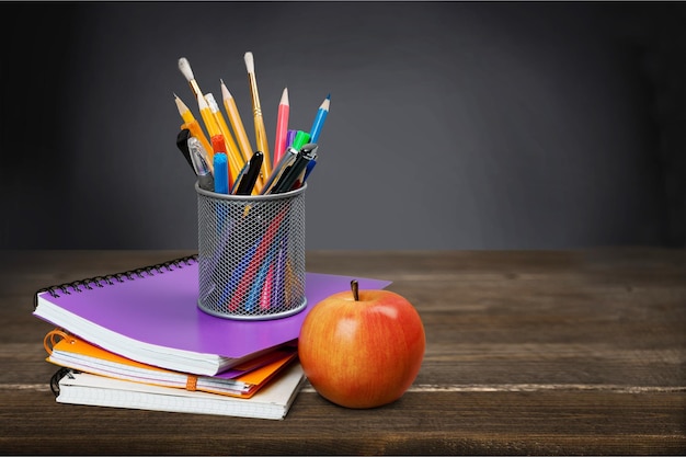 Colorful school supplies on blackboard background