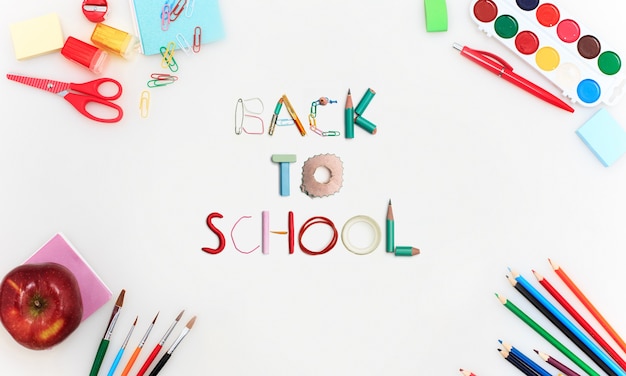 Colorful school supplies corner border over a white background. Education, school time