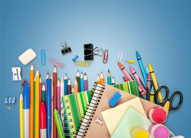 Colorful school supplies on light background