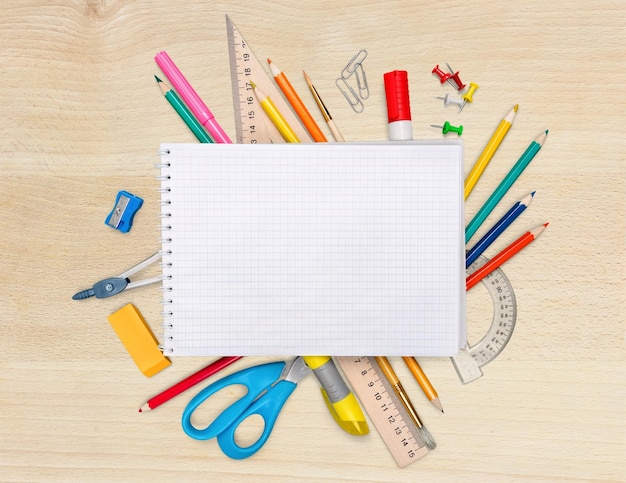 Colorful school supplies on wooden  background