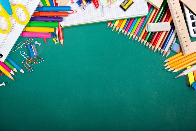 Colorful school supplies on wooden background