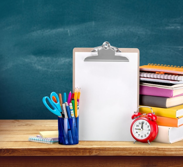 Colorful school supplies on wooden background