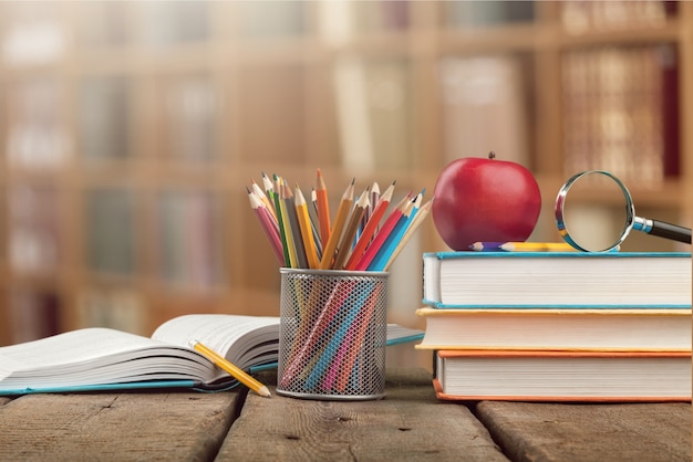 Colorful school supplies on wooden background