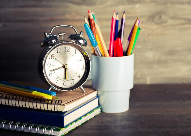 Colorful school supplies on wooden background