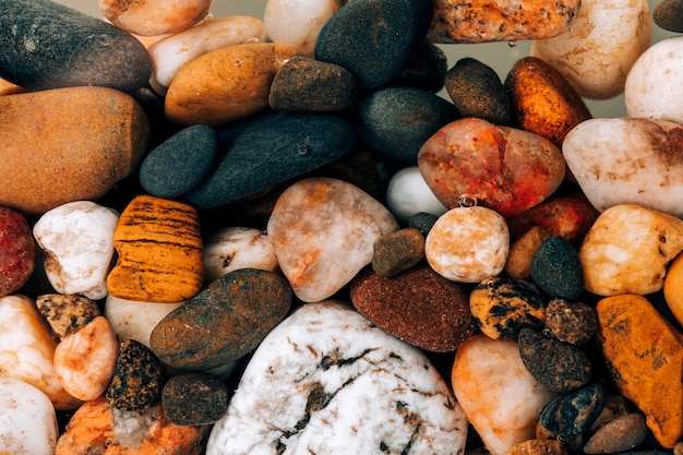 Colorful sea pebbles close-up. Background texture, sea stones in the water.