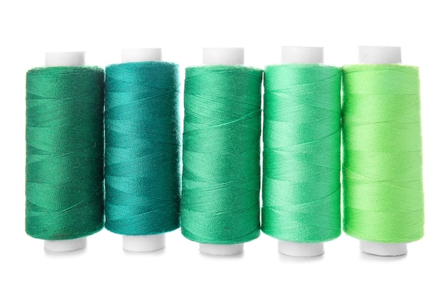 Photo colorful sewing threads on white