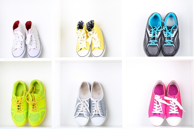 Colorful shoes on wooden shelves