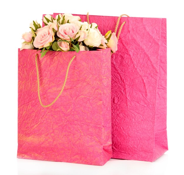 Colorful shopping bags and flowers isolated on white