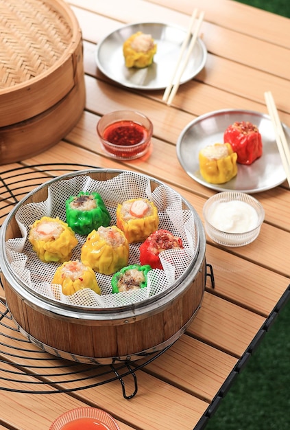 Colorful Siu Mai or Shumai Siomai Dumpling Dimsum with various Topping on Chinese Bamboo Steamer