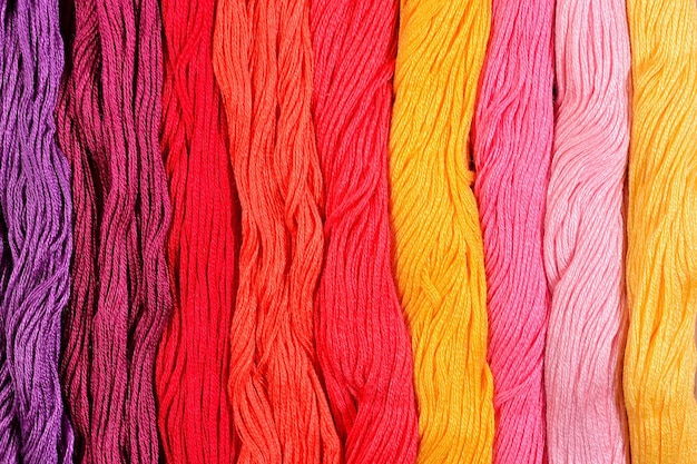 Photo colorful skeins of floss as background texture close up