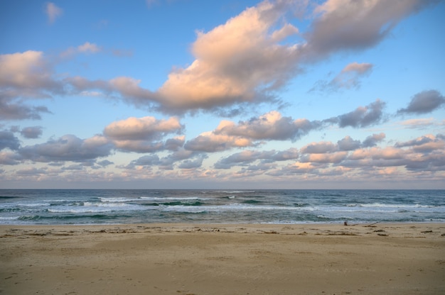 Colorful sky with clouds on horinzon at the beach in evening