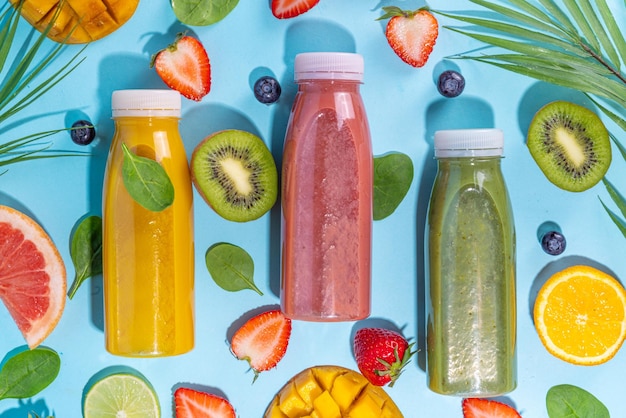 Colorful smoothies in glass bottles