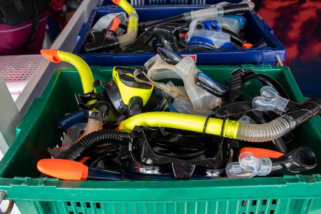 Colorful snorkel mask in plastic crate