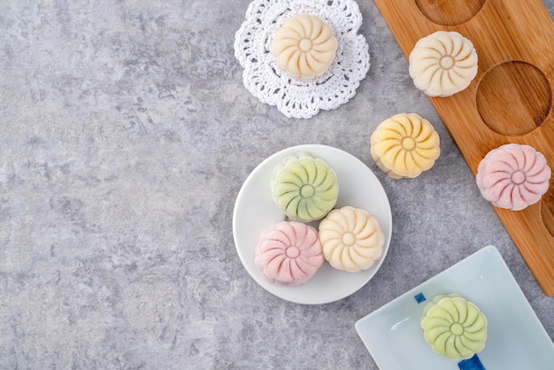 Colorful snow skin moon cake sweet snowy mooncake traditional savory dessert for MidAutumn Festival on gray cement background top view