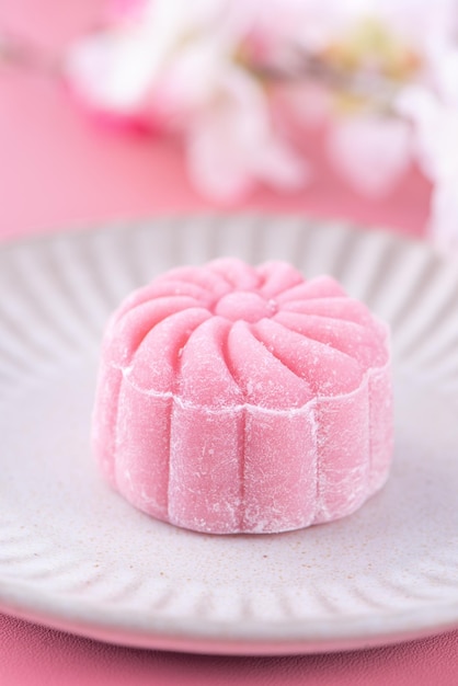 Photo colorful snow skin moon cake sweet snowy mooncake traditional savory dessert for midautumn festival on pastel pale pink background close up lifestyle