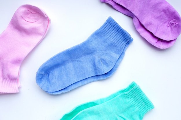 Colorful socks on white surface