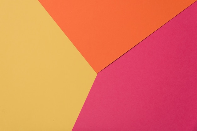 Красочная мягкая желтая, оранжевая и малиновая бумажная предпосылка.