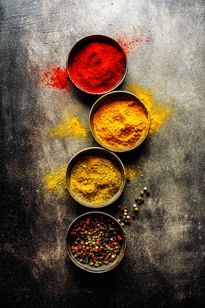 Colorful spices on dark surface