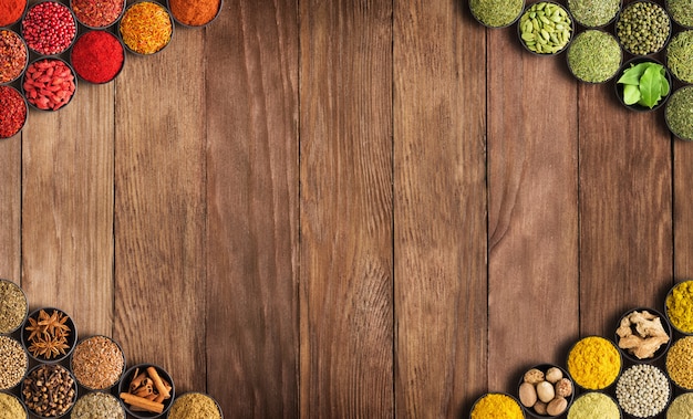 Photo colorful spices and herbs on a wooden table