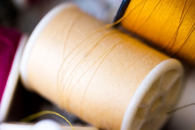 Colorful spools of thread in a pile in tailor shop.