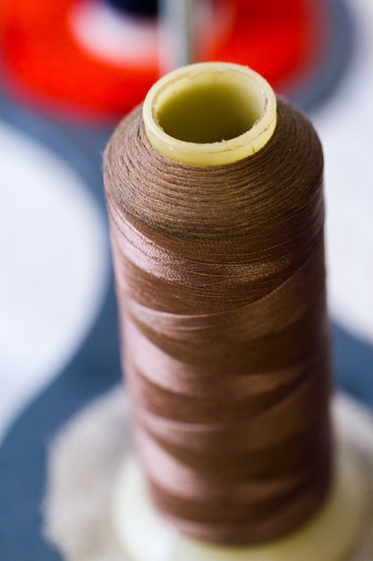 Colorful spools of thread on the stand in tailor shop.