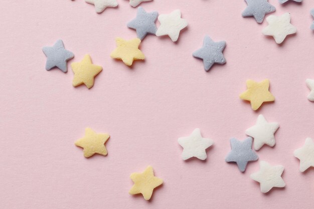 Colorful sprinkles on a pink background, top view with copy space. Easter holiday. Birthday celebration.