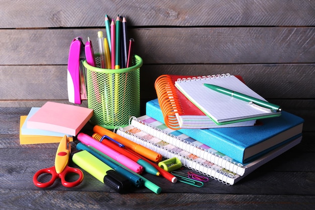 Photo colorful stationery on wooden background