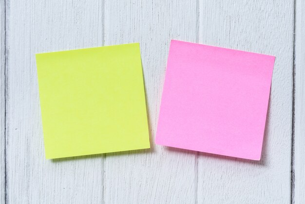 Photo colorful sticky note, post note on white wooden vintage background
