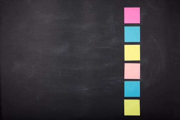 Colorful sticky notes on the blank blackboard