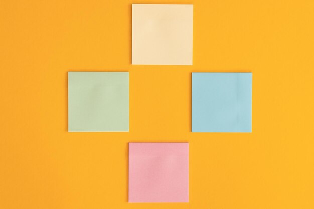 Colorful sticky notes and different wooden arrows on yellow background