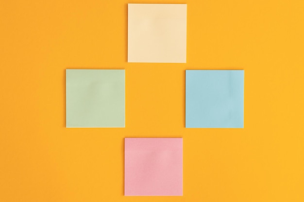 Colorful sticky notes and different wooden arrows on yellow background