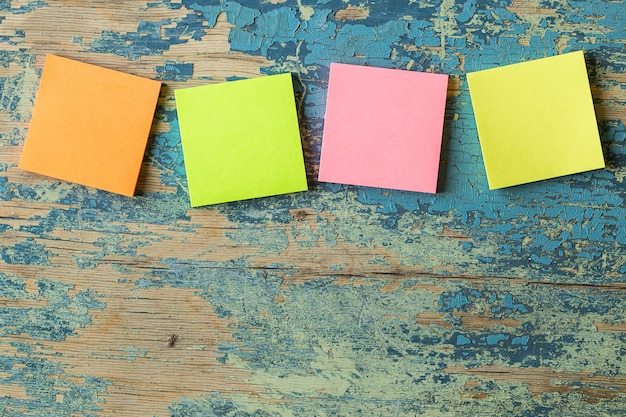 Colorful sticky notes on rustic wooden.