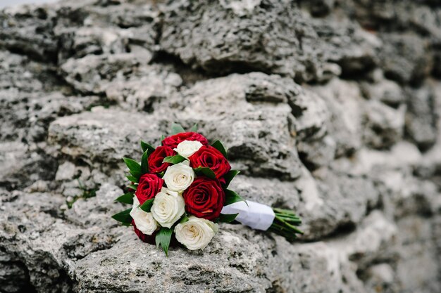 Colorful stylish wedding bouquet made of flowers lies on a gray background Bouquet of the bride on stone Nobody Top view