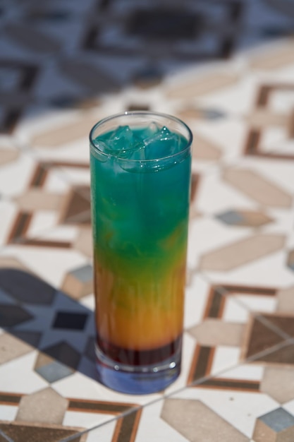 Colorful summer cocktail glass with ice
