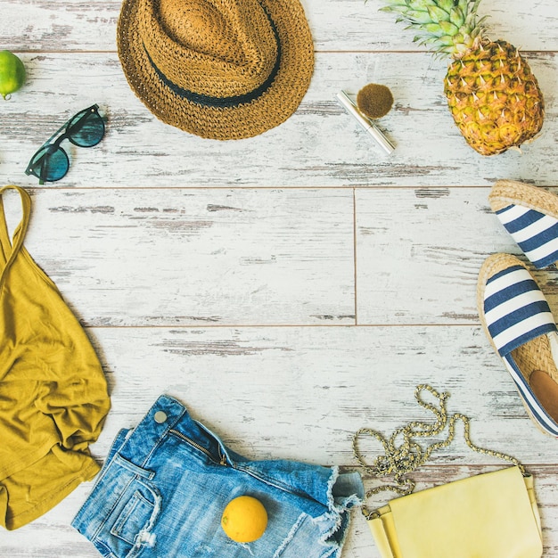 Colorful summer fashion outfit flatlay over parquet background square crop