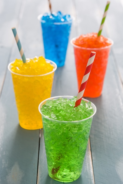 青い木製のテーブルにカラフルな夏slushies