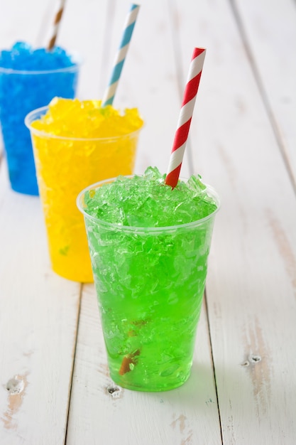 Colorful summer slushies on white wooden table